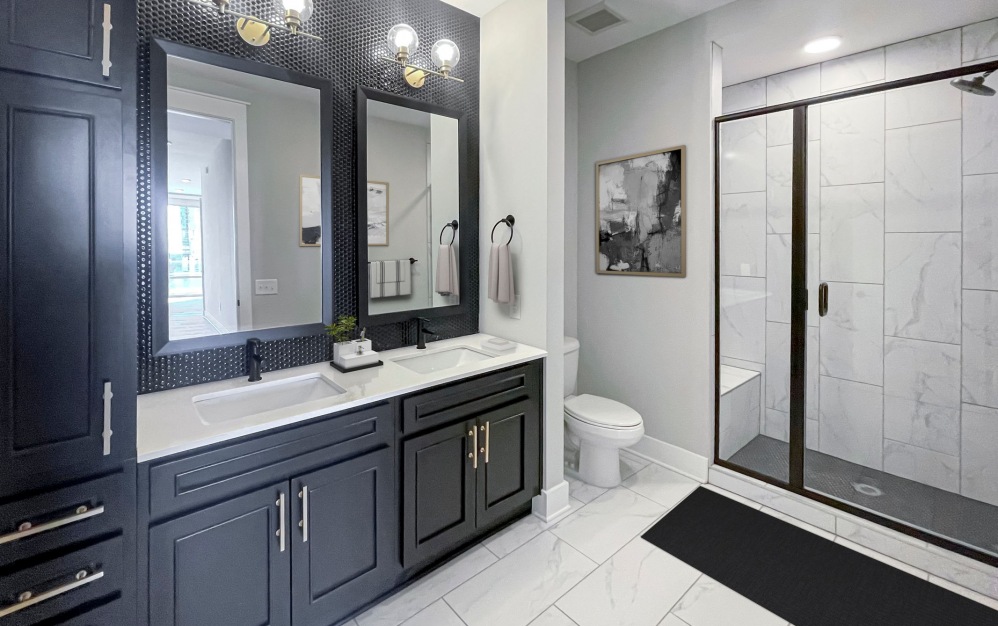 Beautiful bathroom with double vanity sinks and standing shower