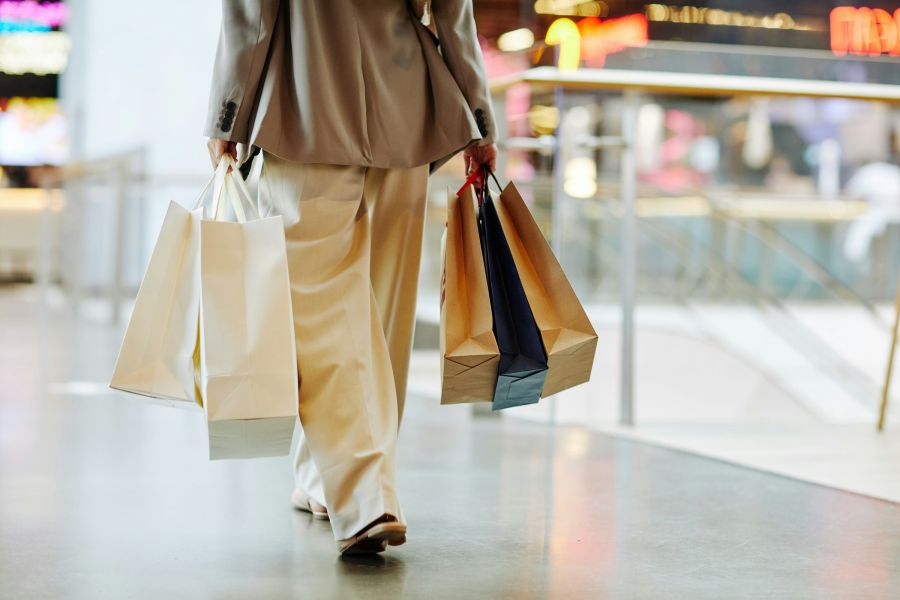 500 West Trade apartments in Charlotte, NC neighborhood shopping and retail therapy woman walking with shopping bags