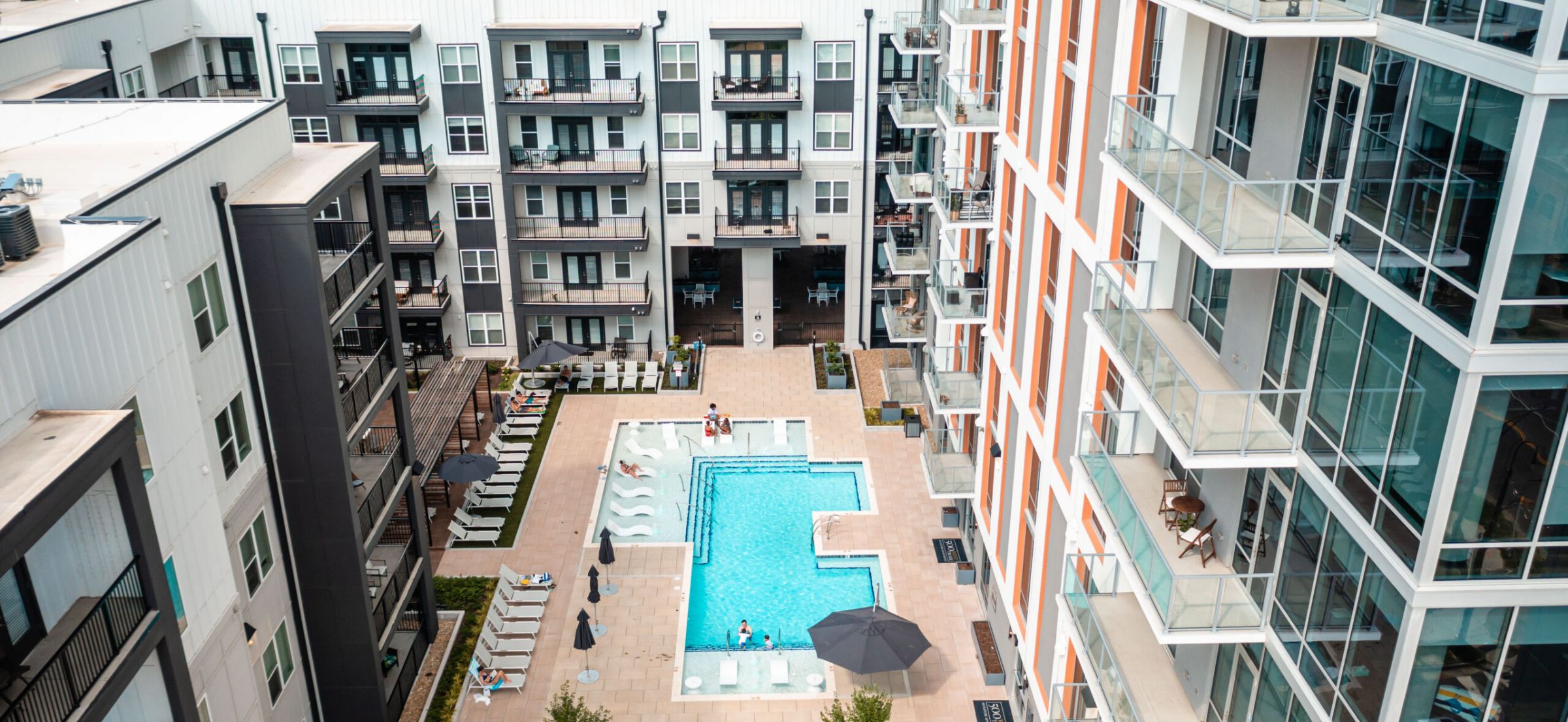 500 West Trade luxury apartments building building exterior community amenities rooftop pool with beautiful view of the city line and skyscrapers