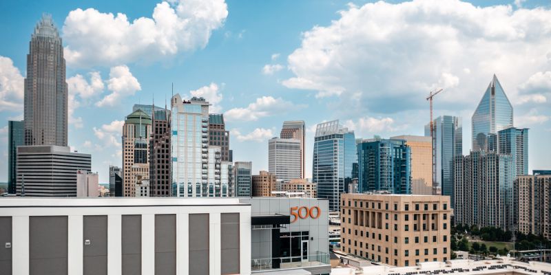 500 West Trade luxury apartments building exterior of the surrounding city during the day with blue sky and beautiful clouds