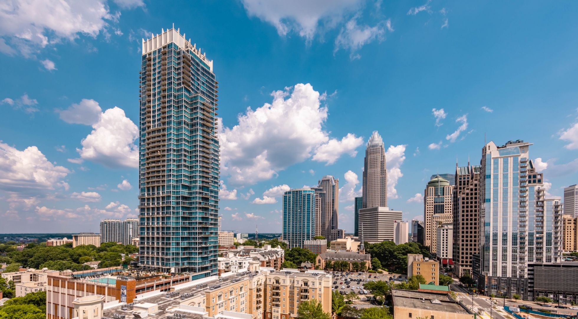 500 West Trade luxury apartments building exterior of the surrounding city during the day with blue sky and beautiful clouds
