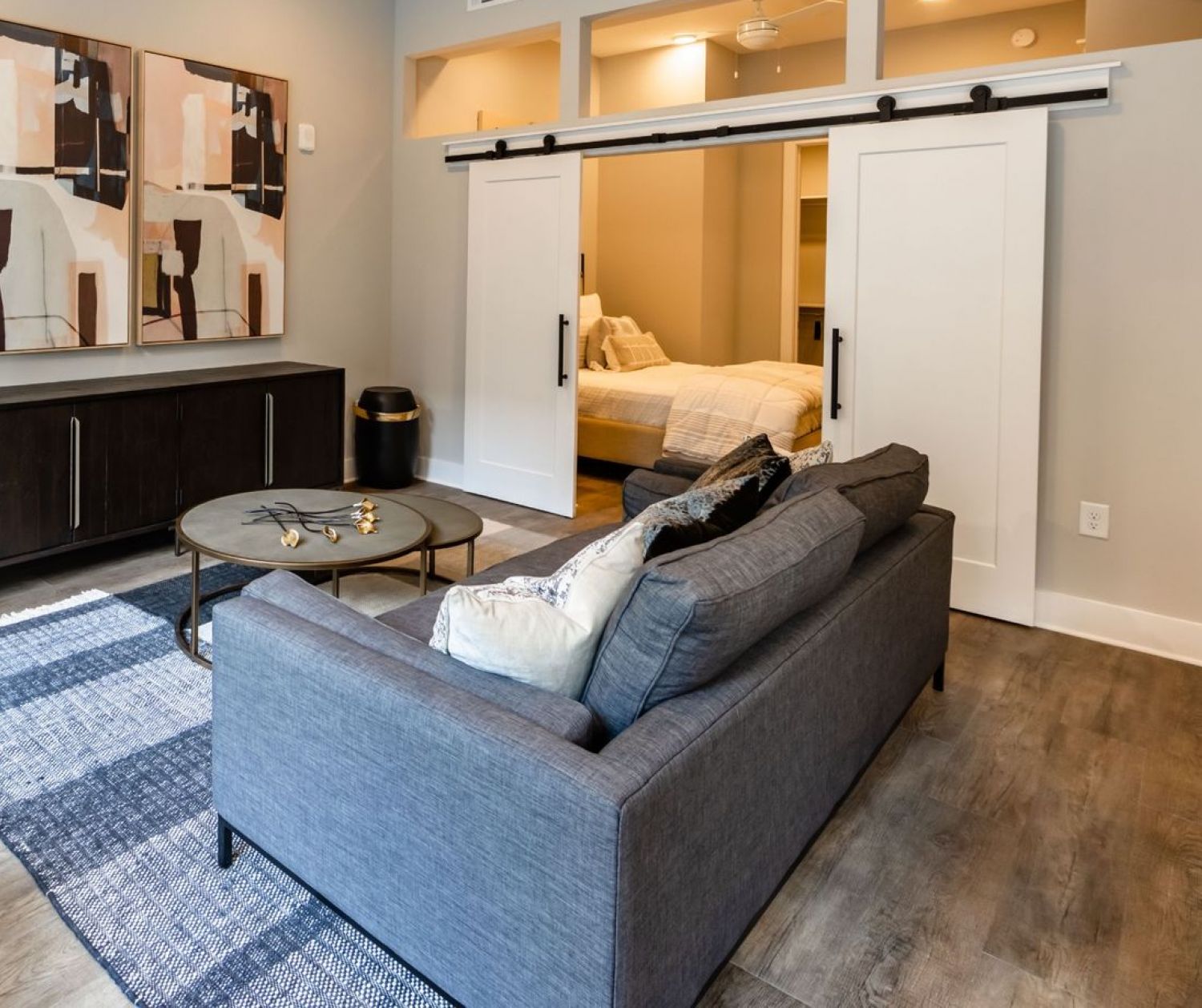 500 West Trade luxury apartment with living room, couch and sliding barn doors