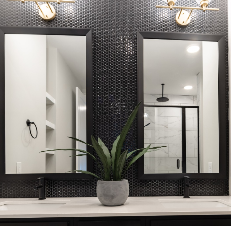 500 West Trade luxury apartment double vanity bathroom with nice lighting and a plant